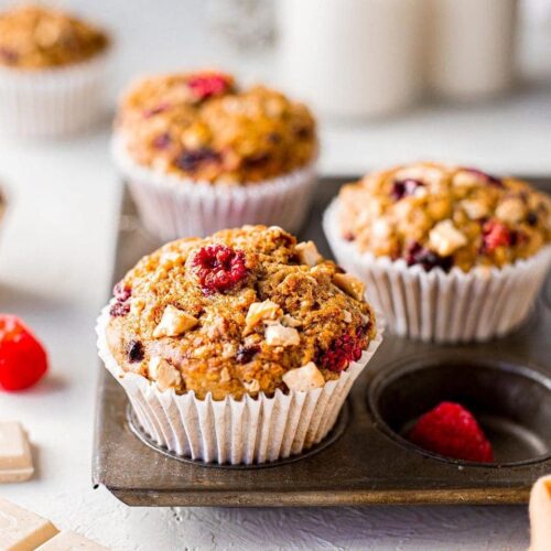 vegan banana raspberry white chocolate muffins close up in tray