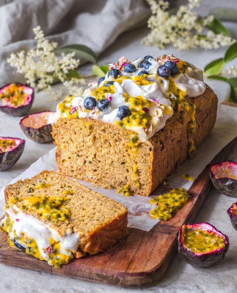 Passionfruit banana bread topped with coconut yoghurt, passionfruit pulp and blueberries.