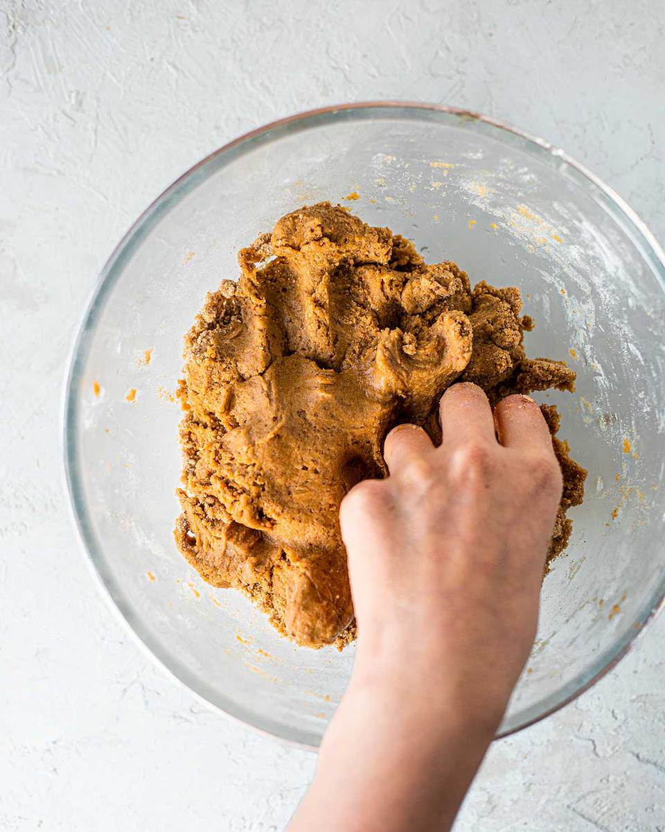 Hand mixing the dough of the refined sugar free gingerbread cookies.