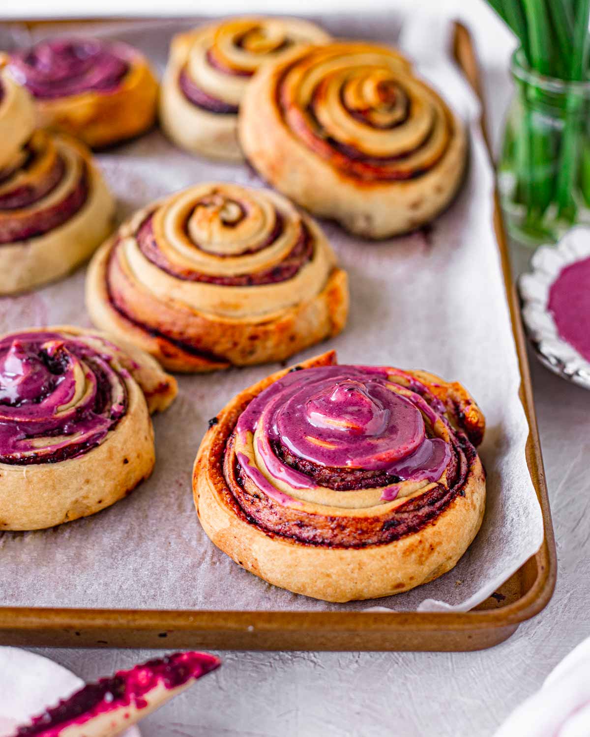 Close up of baked berry swirl buns.