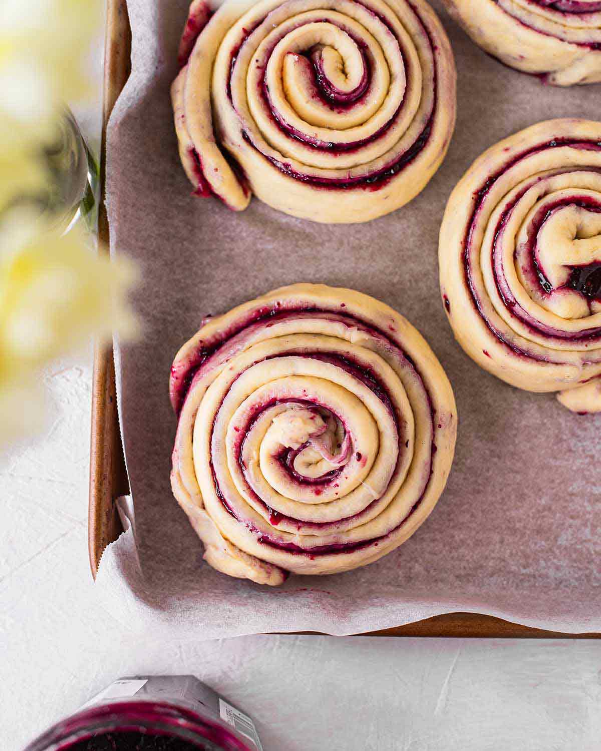 Unbaked berry swirl rolls on tray.