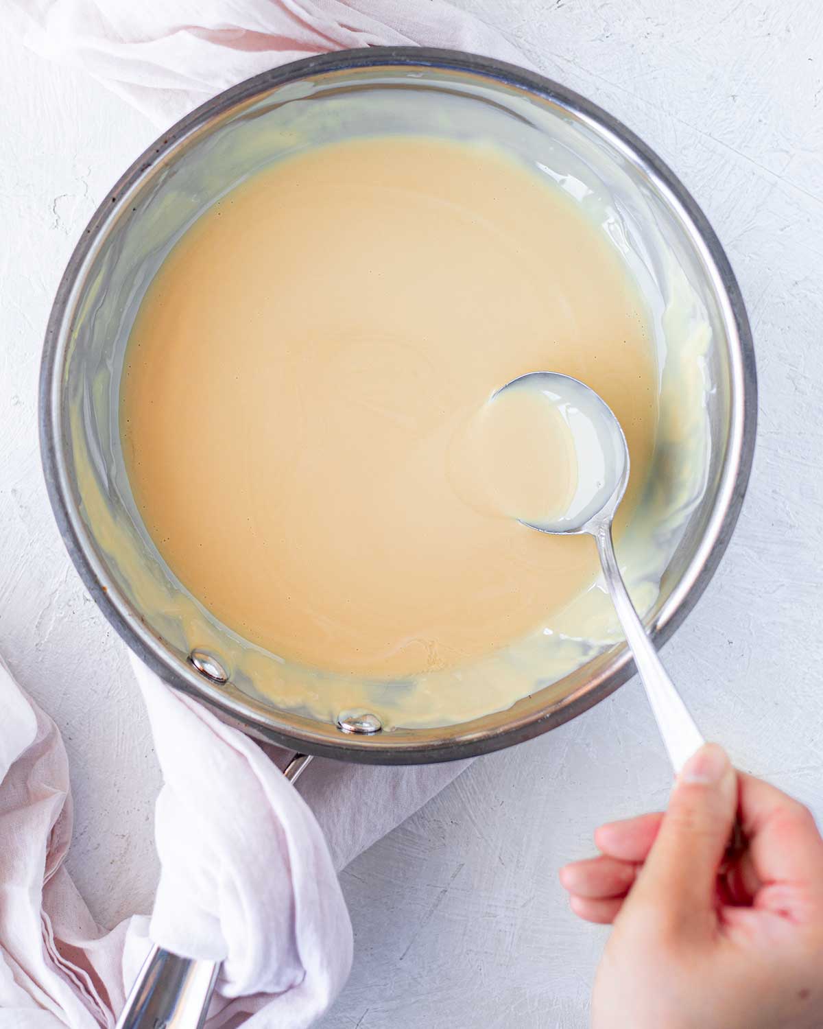Melted white chocolate in saucepan.