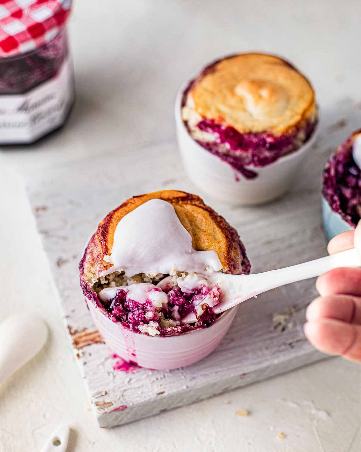 Spoon coming out of one self-saucing pudding showing gooey texture.