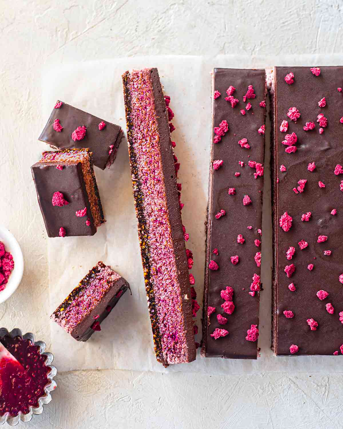 Long slabs showing the layers of the vegan raspberry bar.