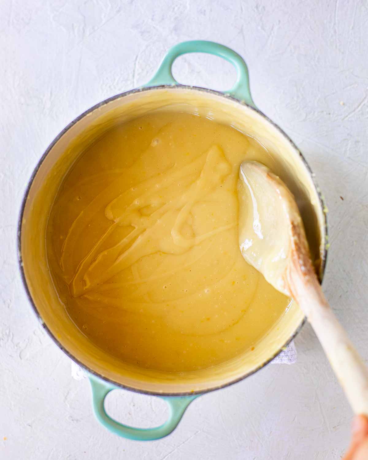 Custard filling ingredients in a white pot showing creamy texture.