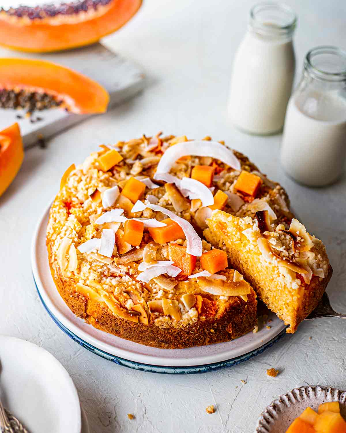 Papaya coconut cake with slice coming out.