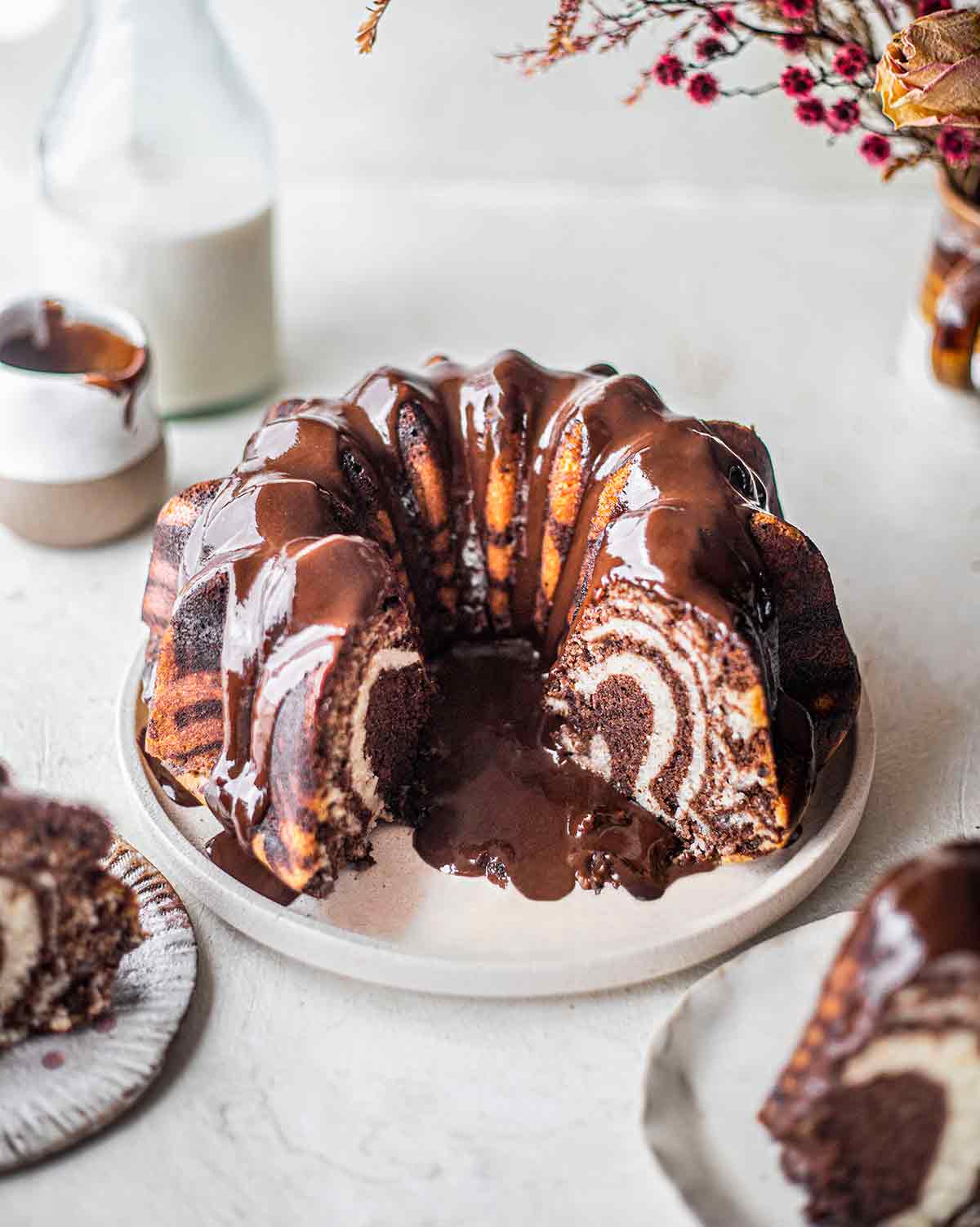 Vegan Zebra Bundt cake cut open revealing vanilla and chocolate layers.