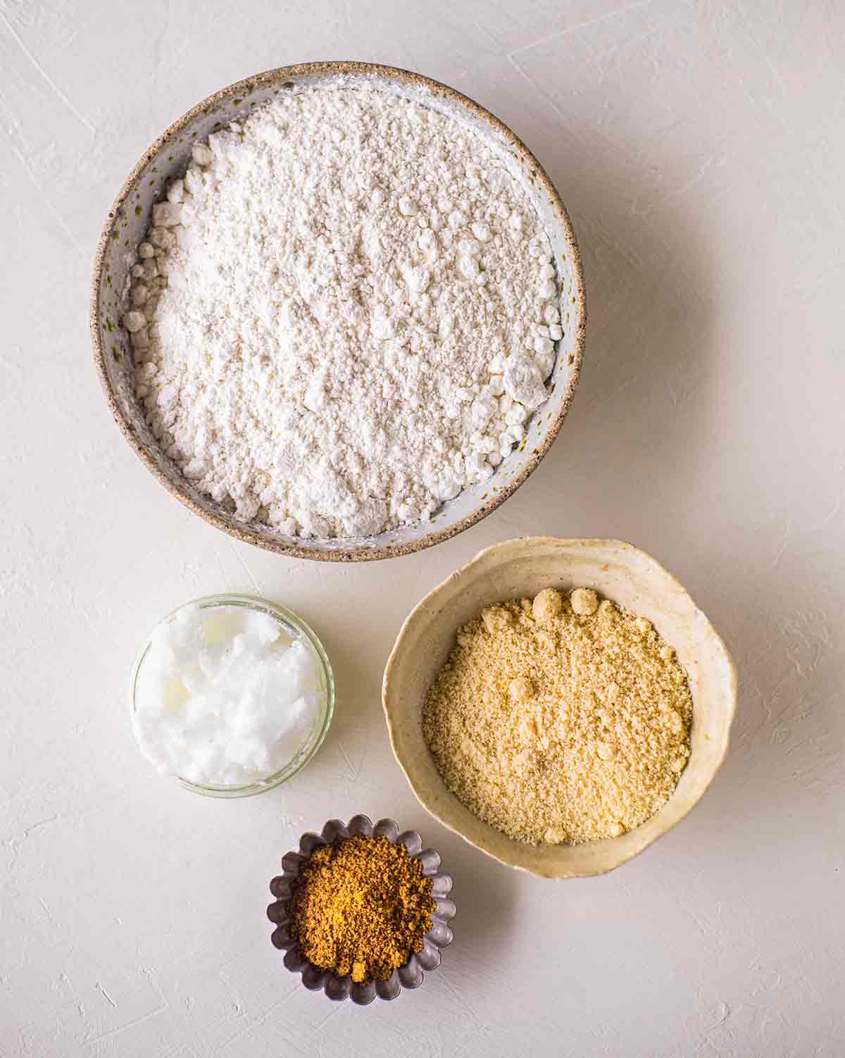 Flatlay of ingredients for the crust of the baked vegan cheescake.