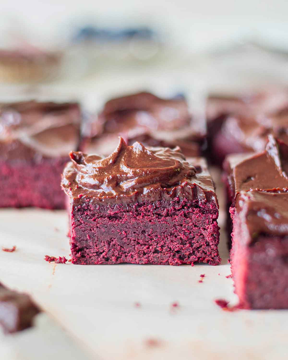 Close up of pink-coloured beetroot brownie with frosting