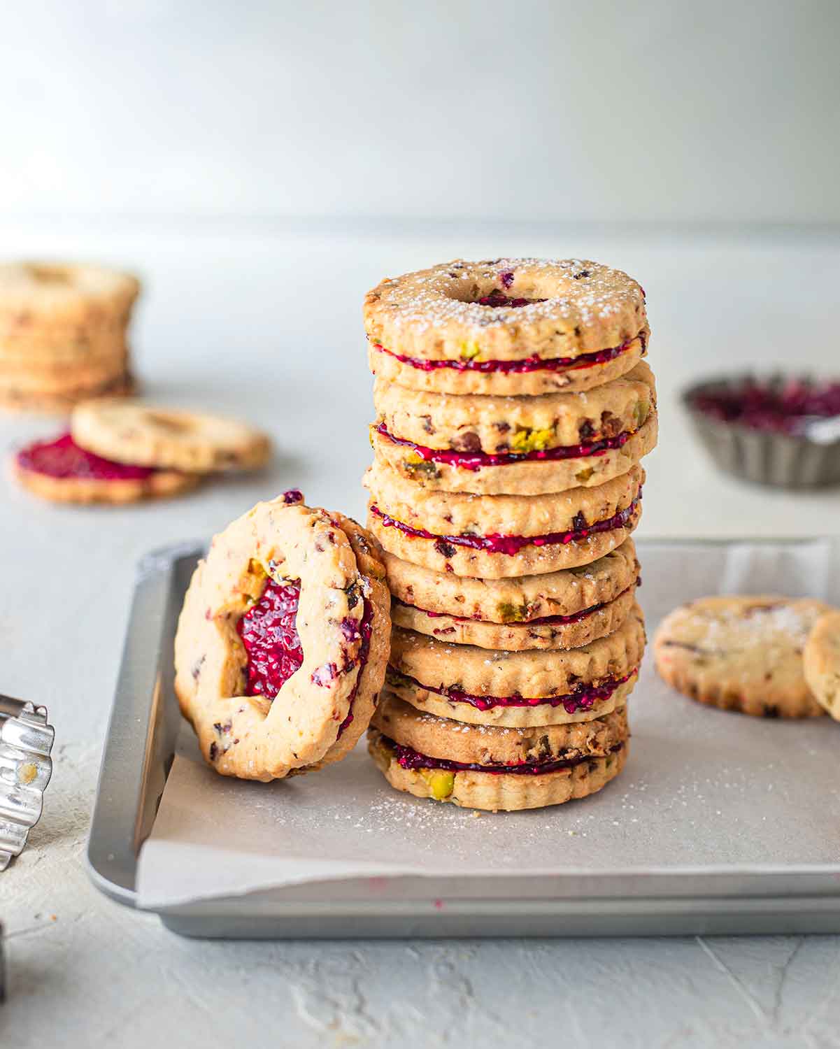 Stack of festive cookies filled with jam.
