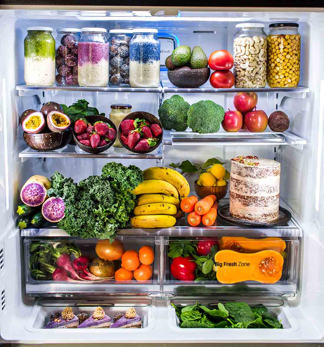 styled image of fridge packed with fresh fruit, vegetables and meal prep.
