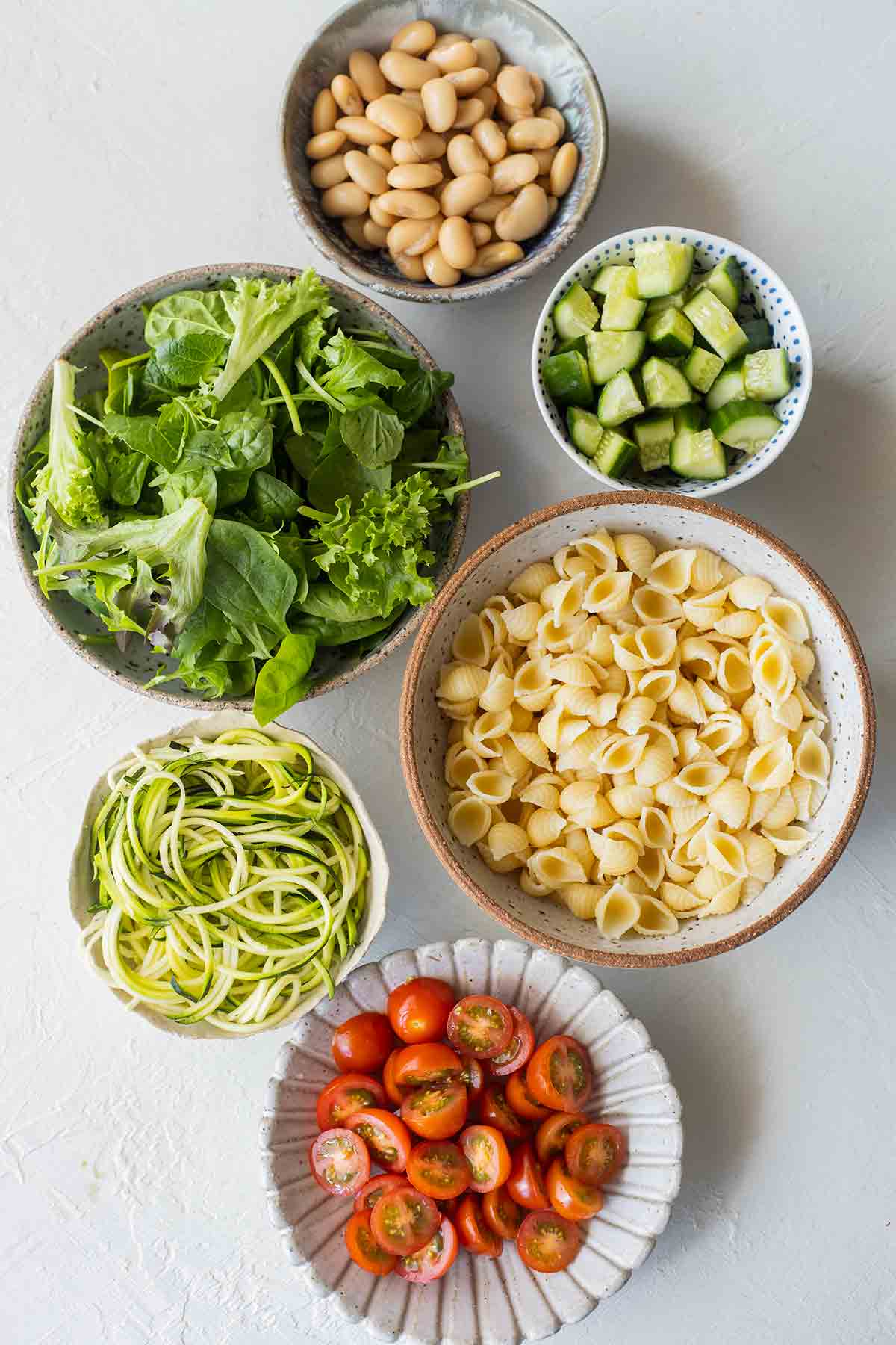Flatlay of salad ingredients for Vegan Layered Pasta Salad.