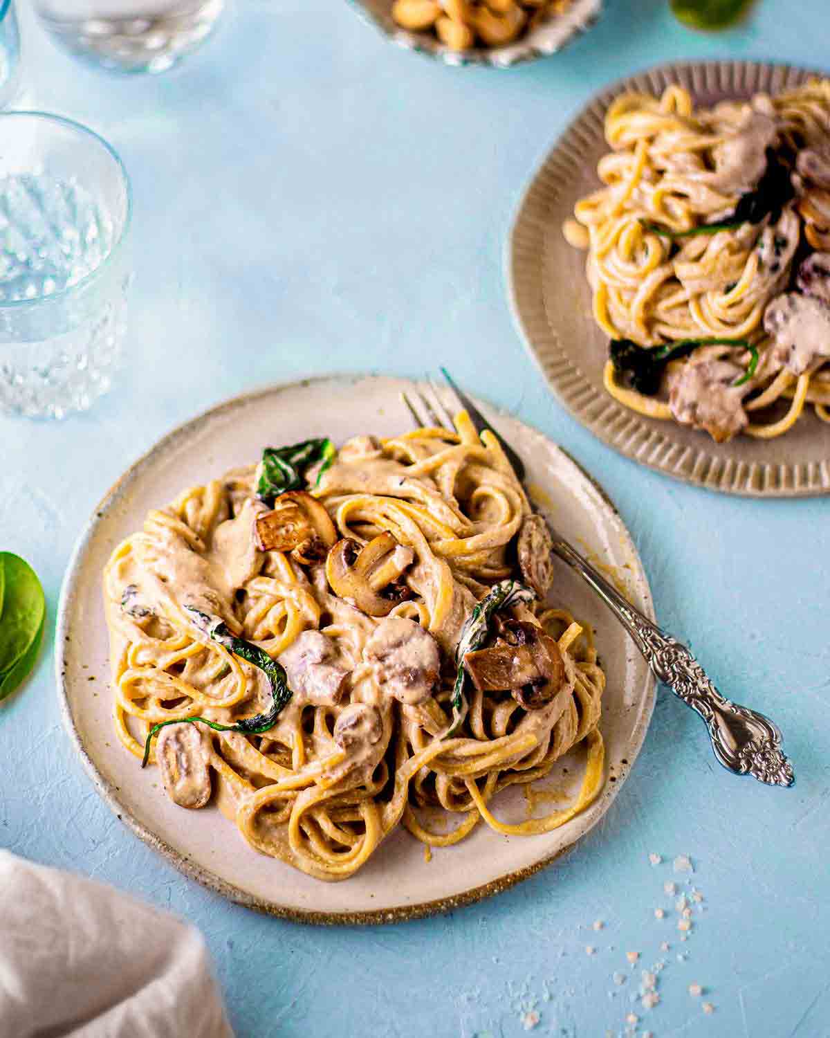 Individual serving of alfredo pasta on plate.