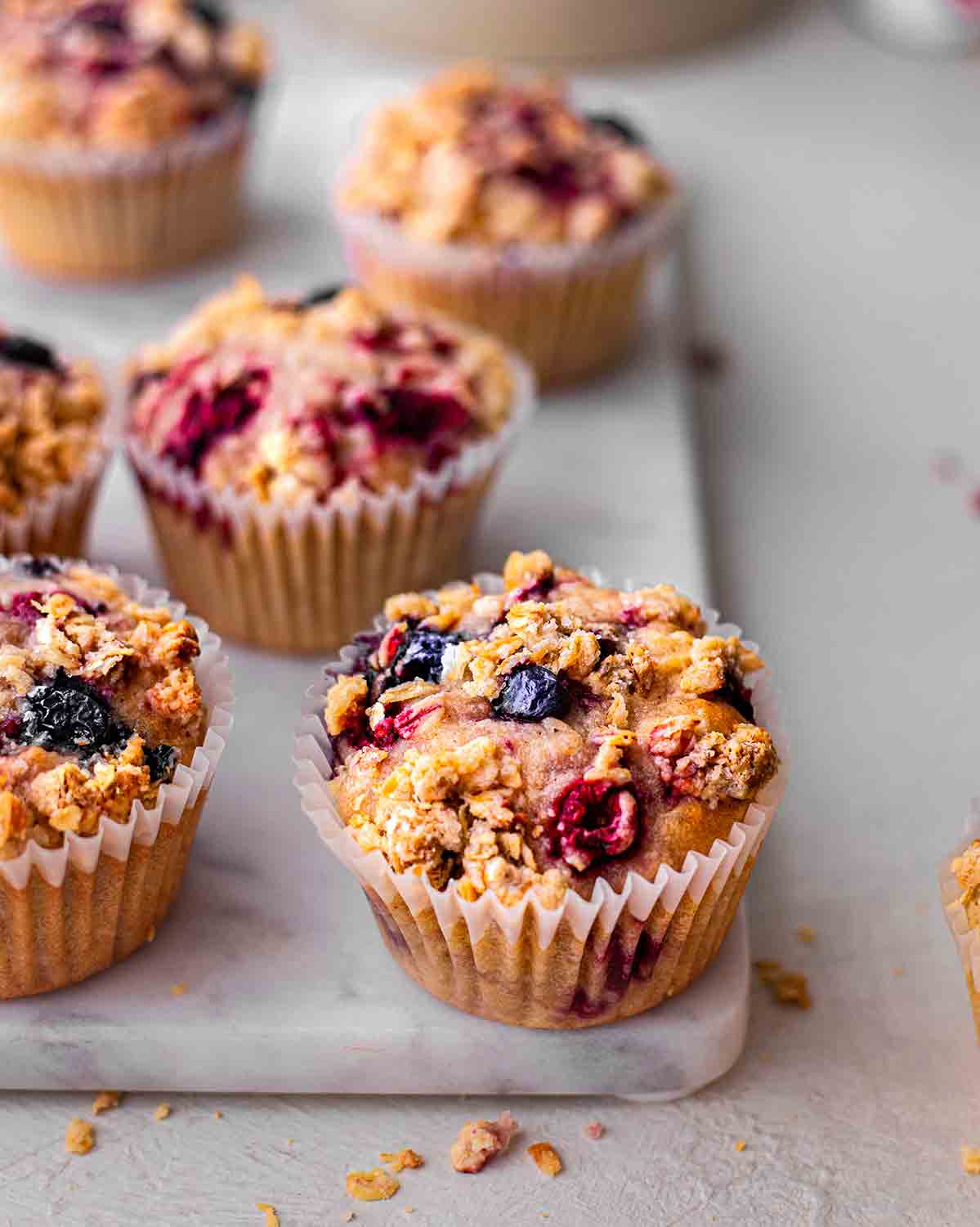 Close up of one apple berry muffin focusing on the crumble topping.