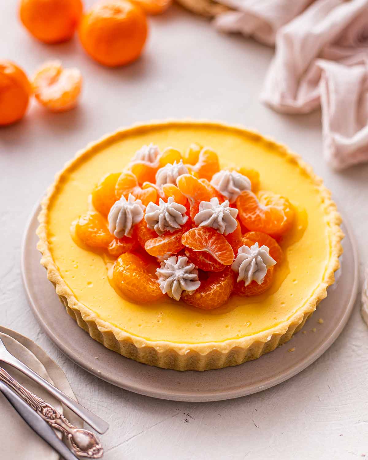 Mandarin tart on white plate.