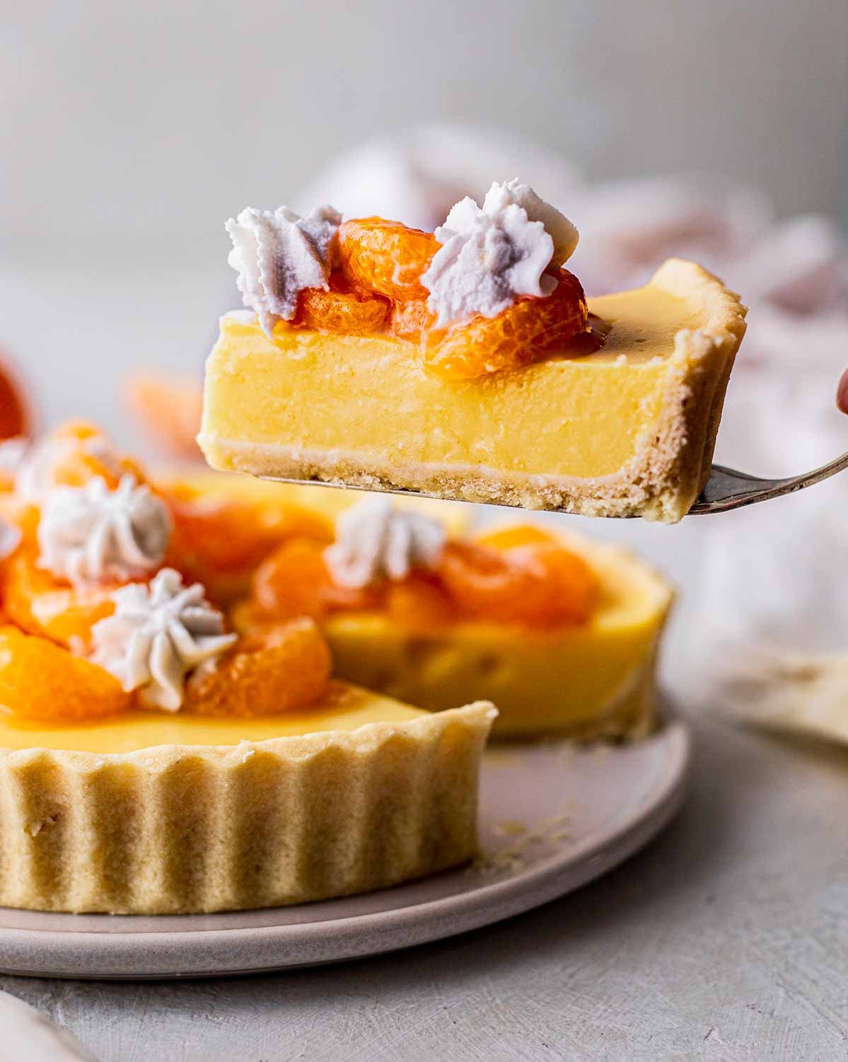 Slice of mandarin tart lifted up.