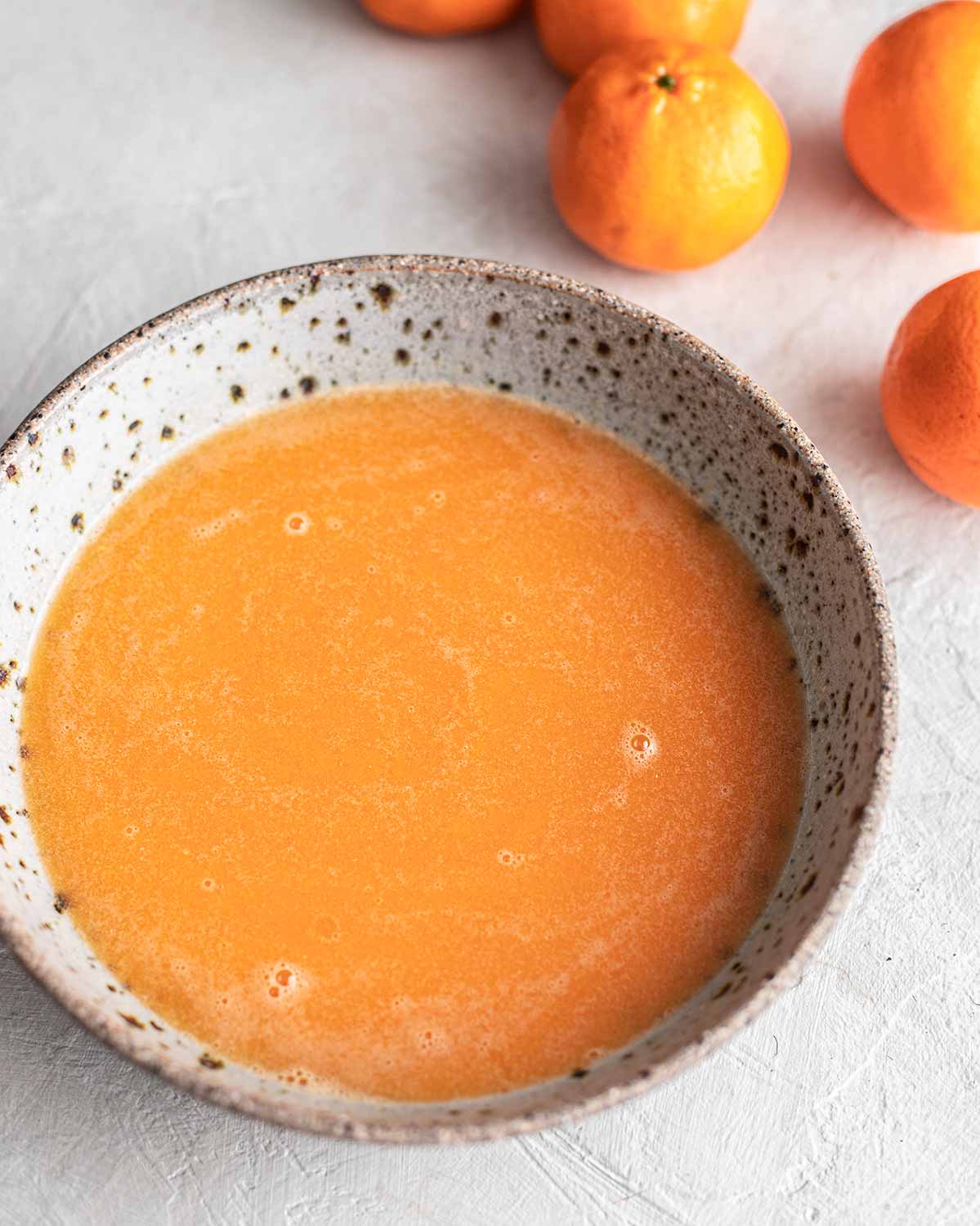 Bright mandarin juice in bowl.