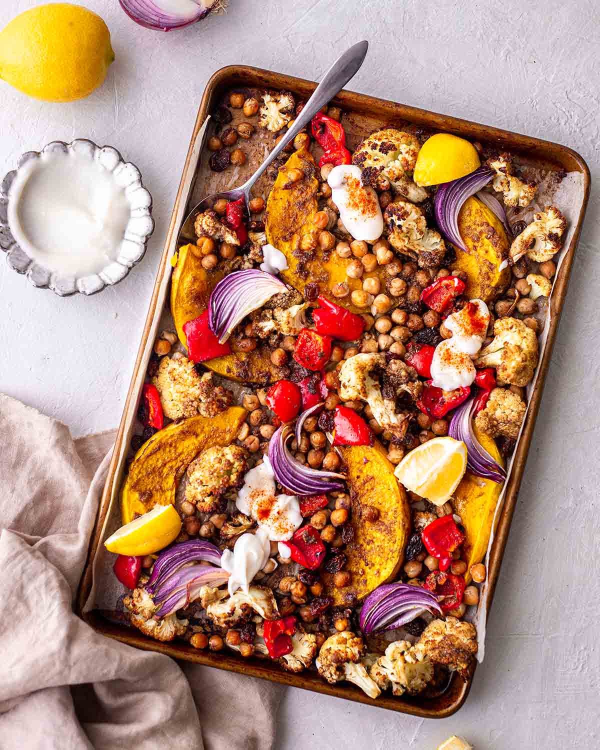 Colourful moroccan vegetable tray bake with a side of coconut yoghurt