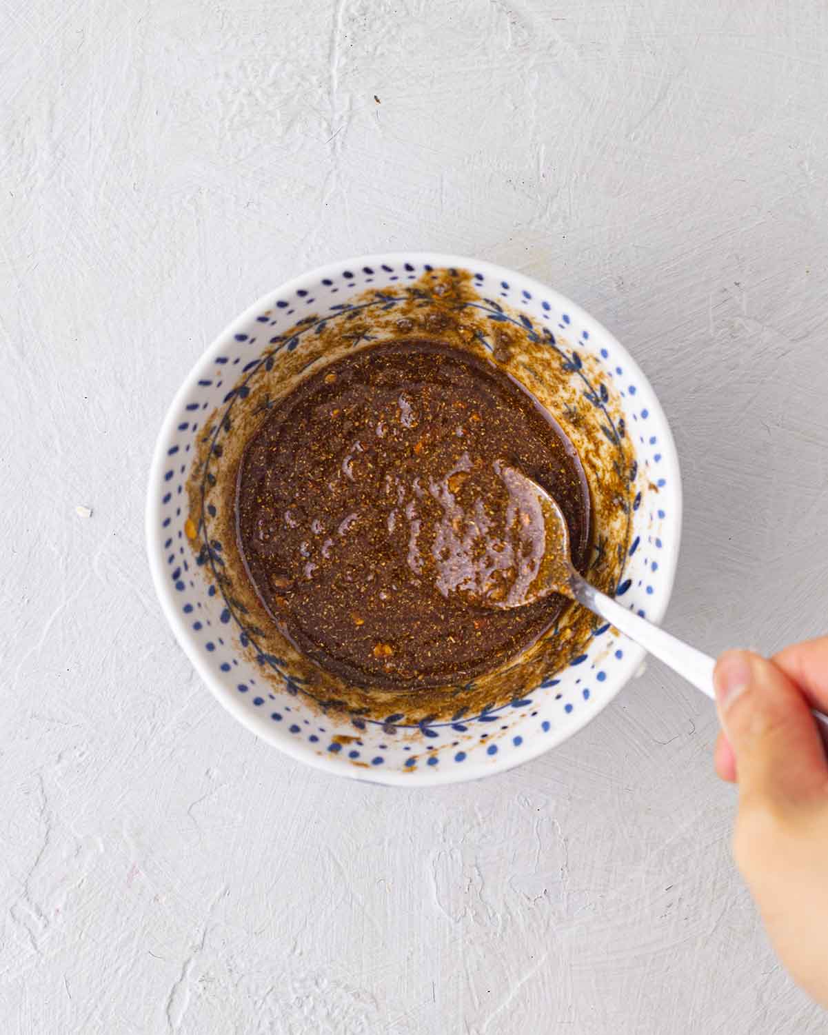 Bowl of spiced dressing made of olive oil, garlic and spices