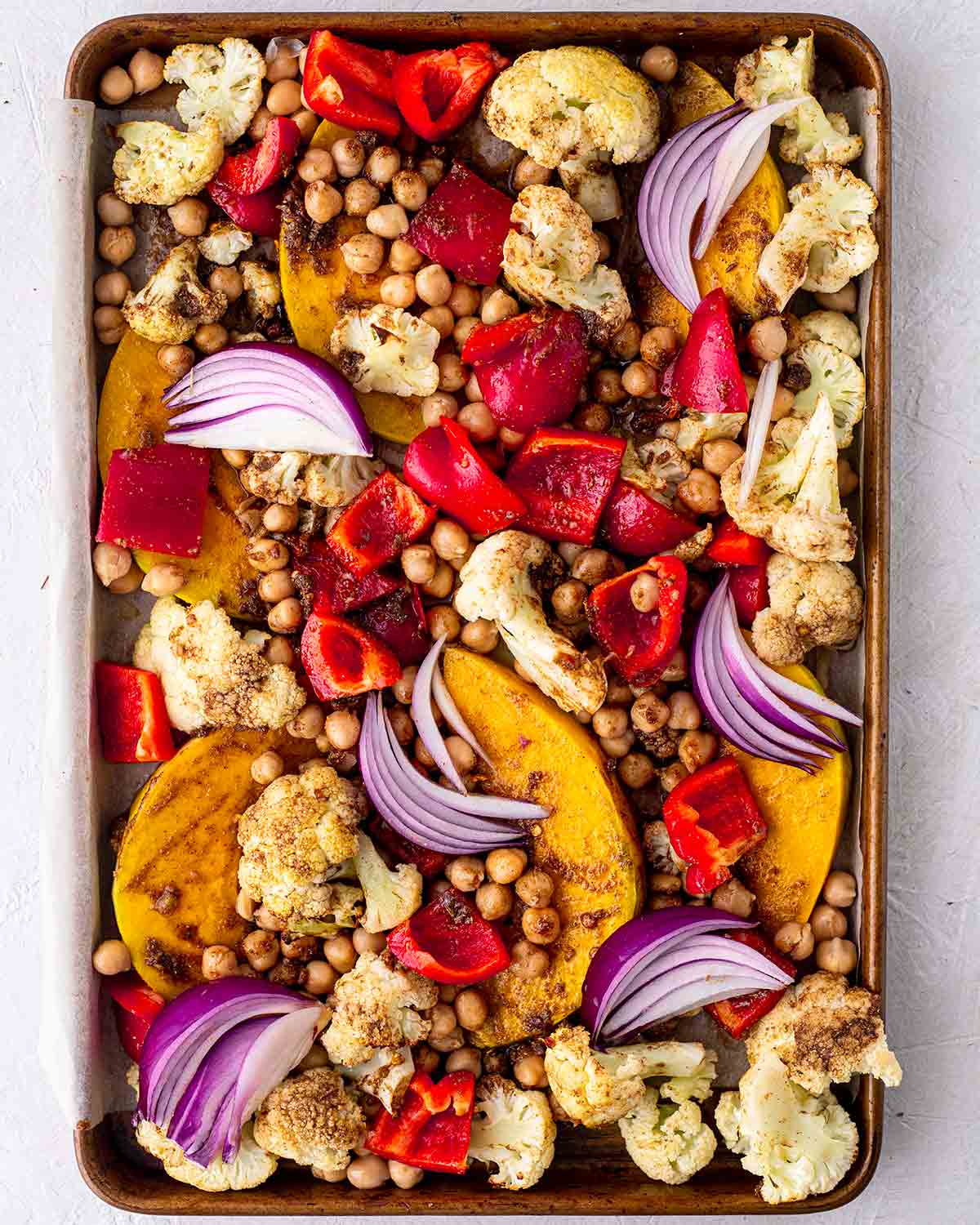 Half baked vegetable tray bake with colourful vegetables and spices