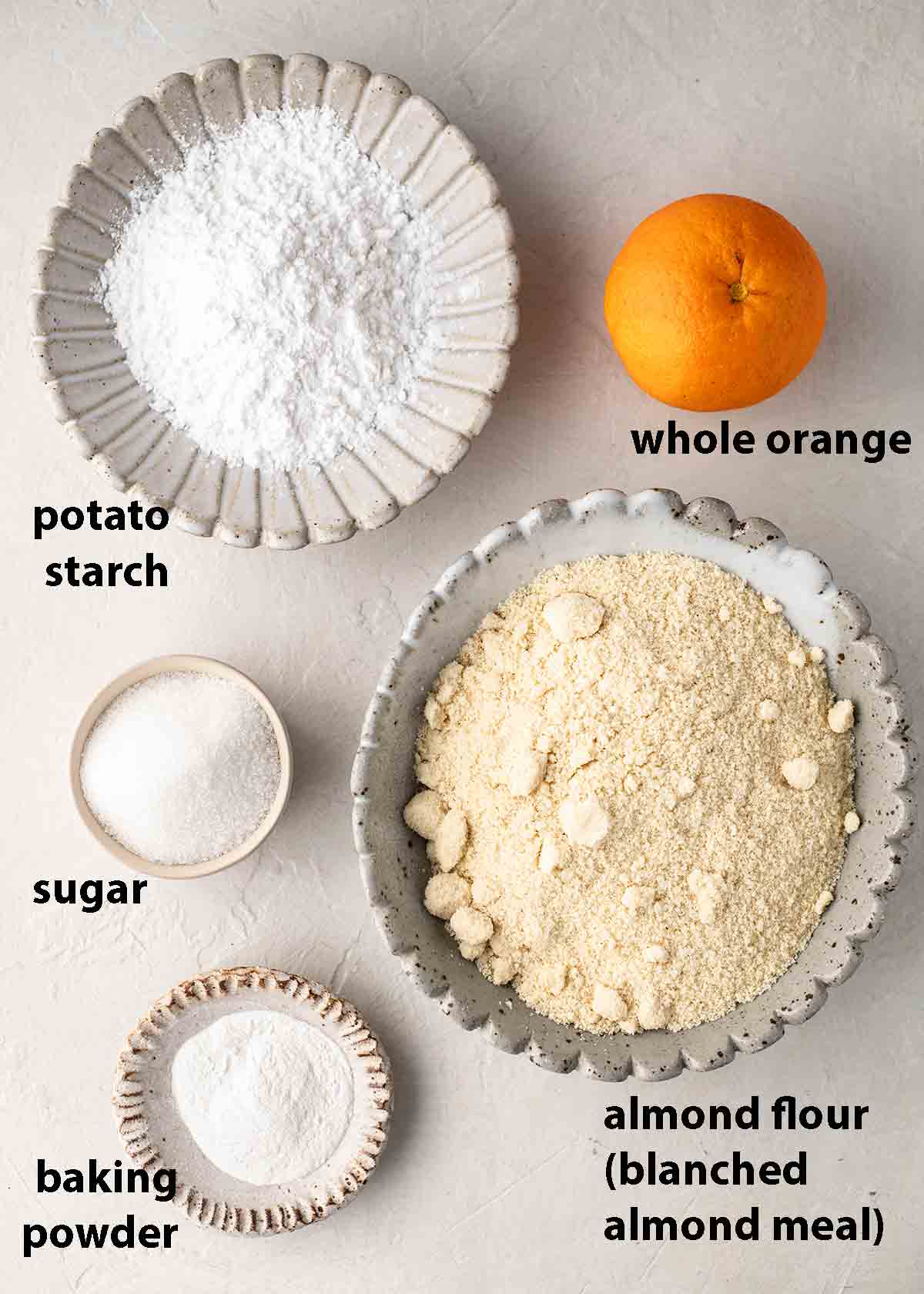 Flatlay of 5 ingredients for vegan whole orange cake