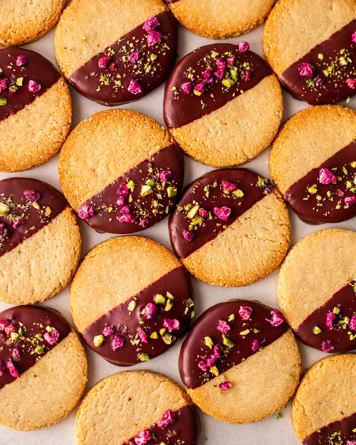 Flatlay of almond flour cookies half dipped in chocolate.