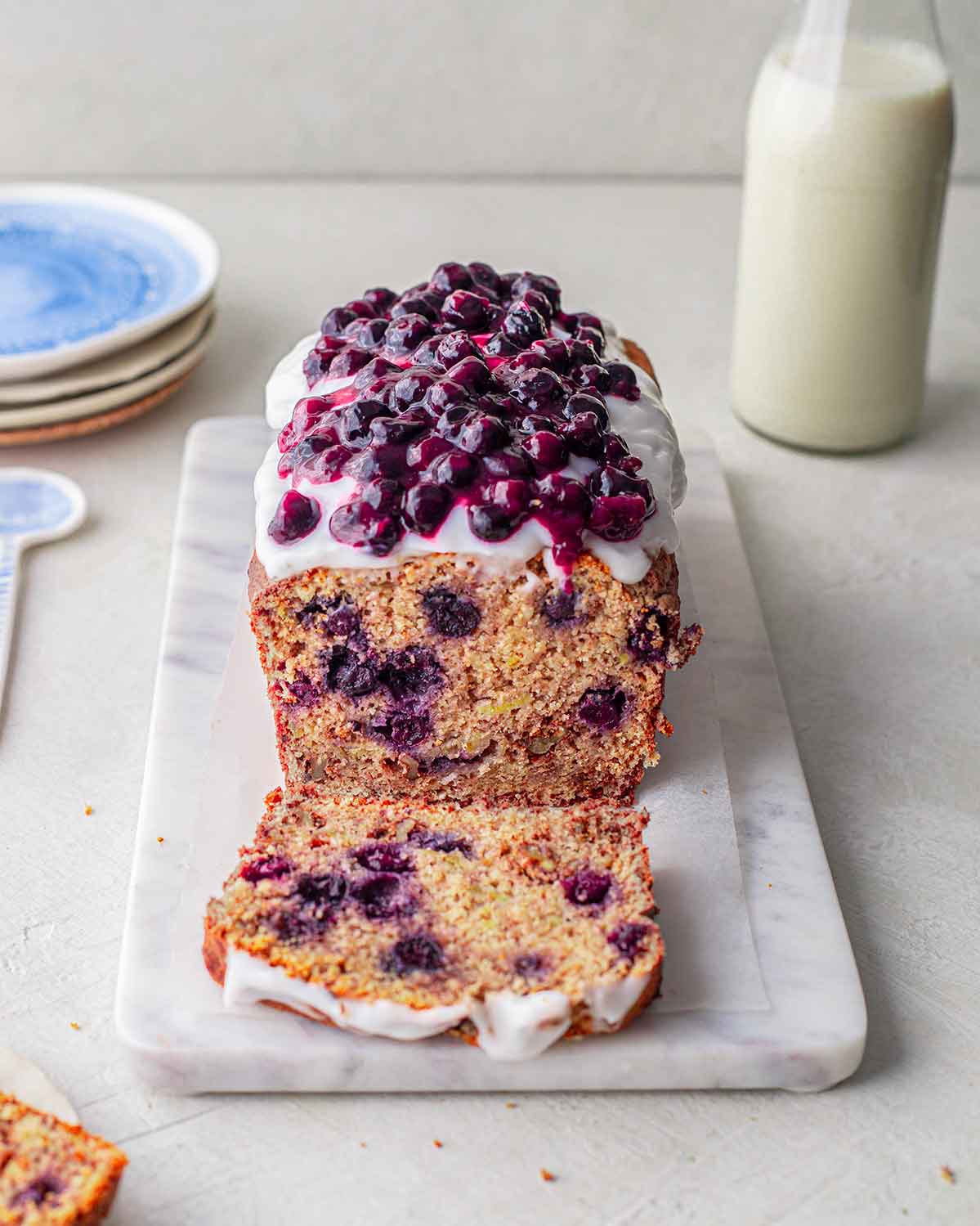 Banana bread topped with coconut yoghurt and stewed blueberries.