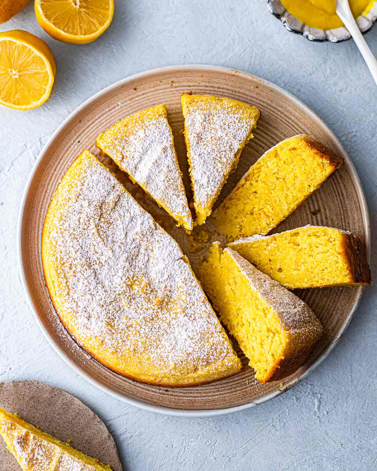 Lemon cake on plate with slices coming out.