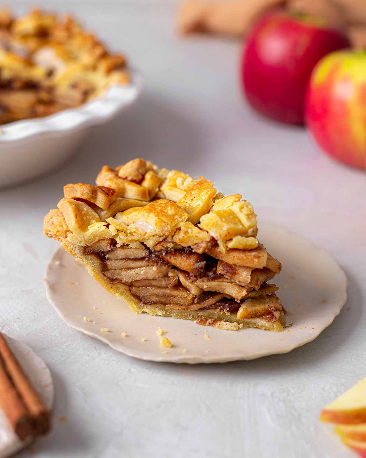 Individual slice of apple pie showing layered of caramelised apples.