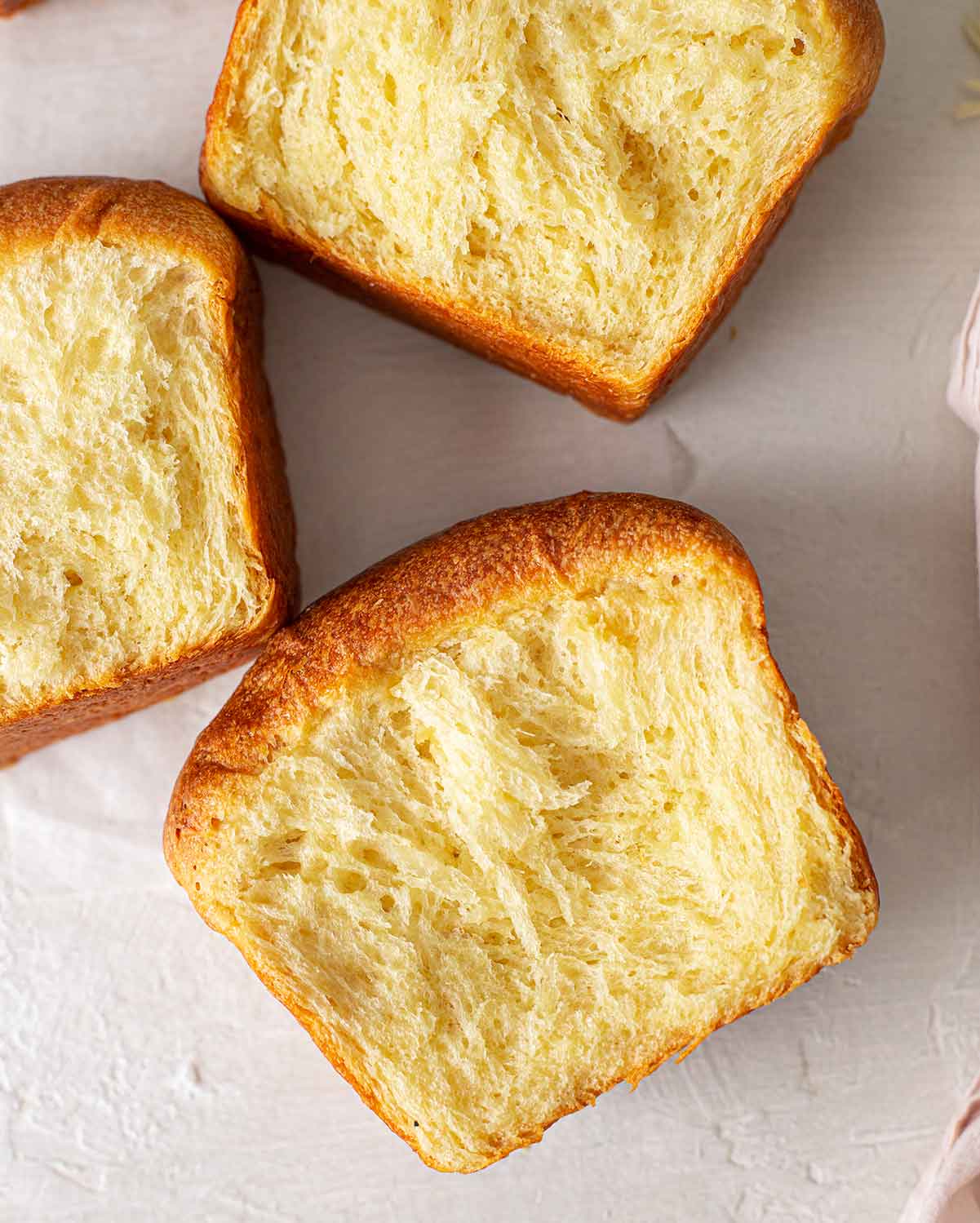 Close up of a few slices of brioche, focusing on their feathery texture.