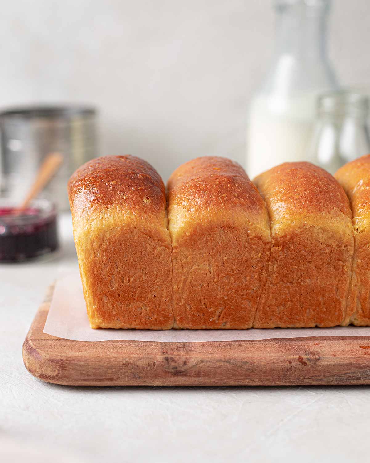 Side image of the golden brioche, showing the curved shape of the loaf.