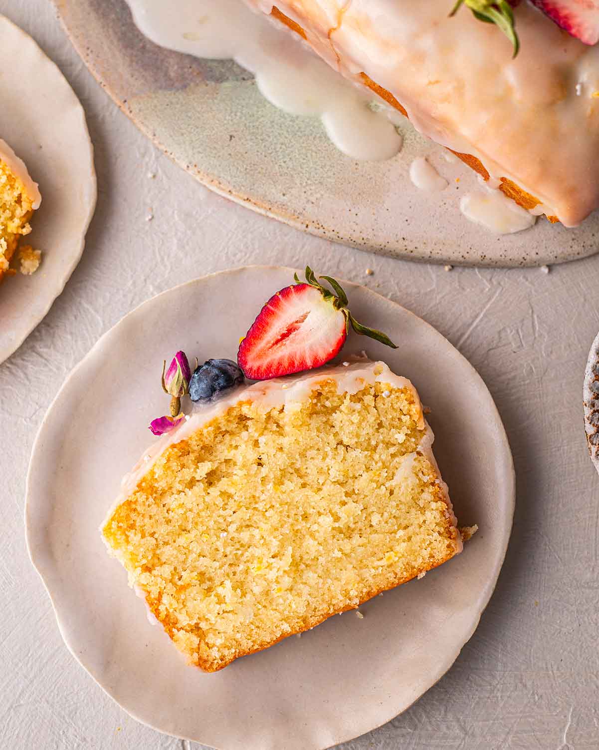 Single slice of lemon loaf showing golden fluffy texture.