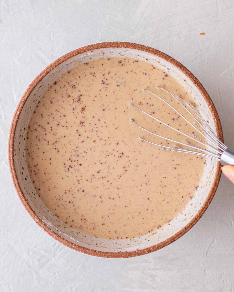 Light brown french toast soaking liquid in bowl.