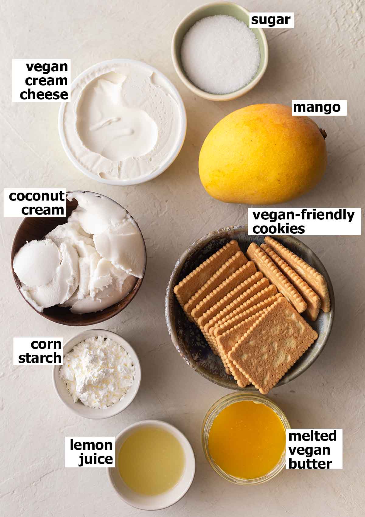 Flatlay of 8 ingredients for the cheesecake.