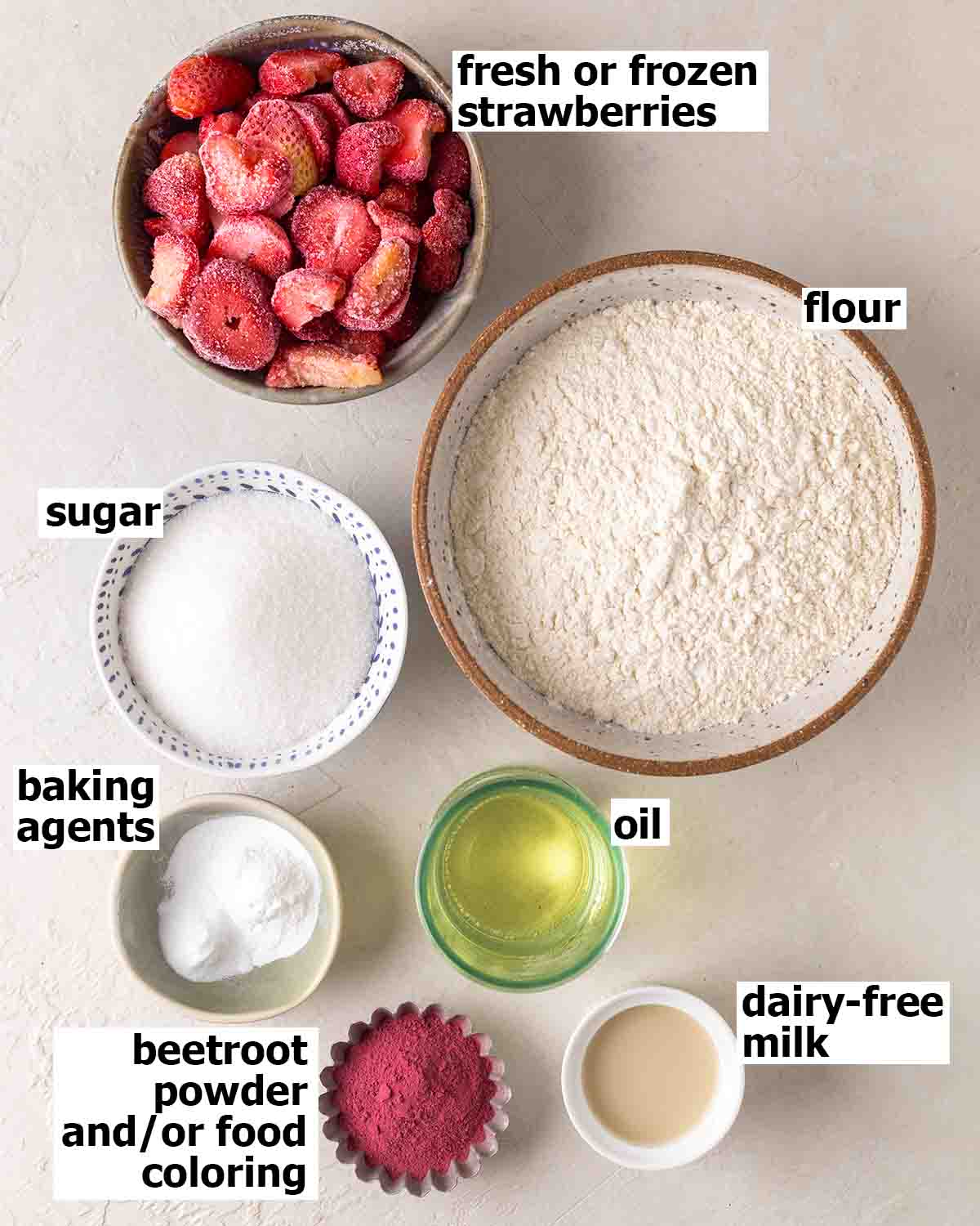 Flat lay of 7 ingredients for strawberry cake.