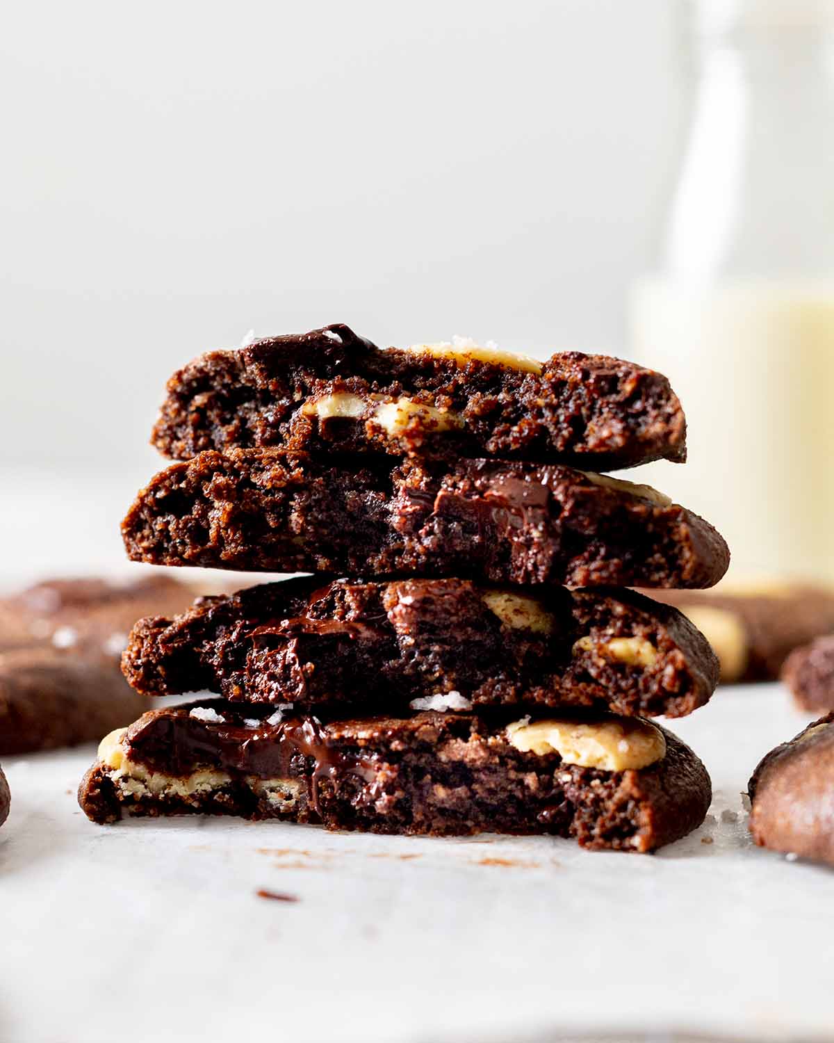 Stack of chocolate cookies showing fudgy interior and melty chocolate chunks and chips.