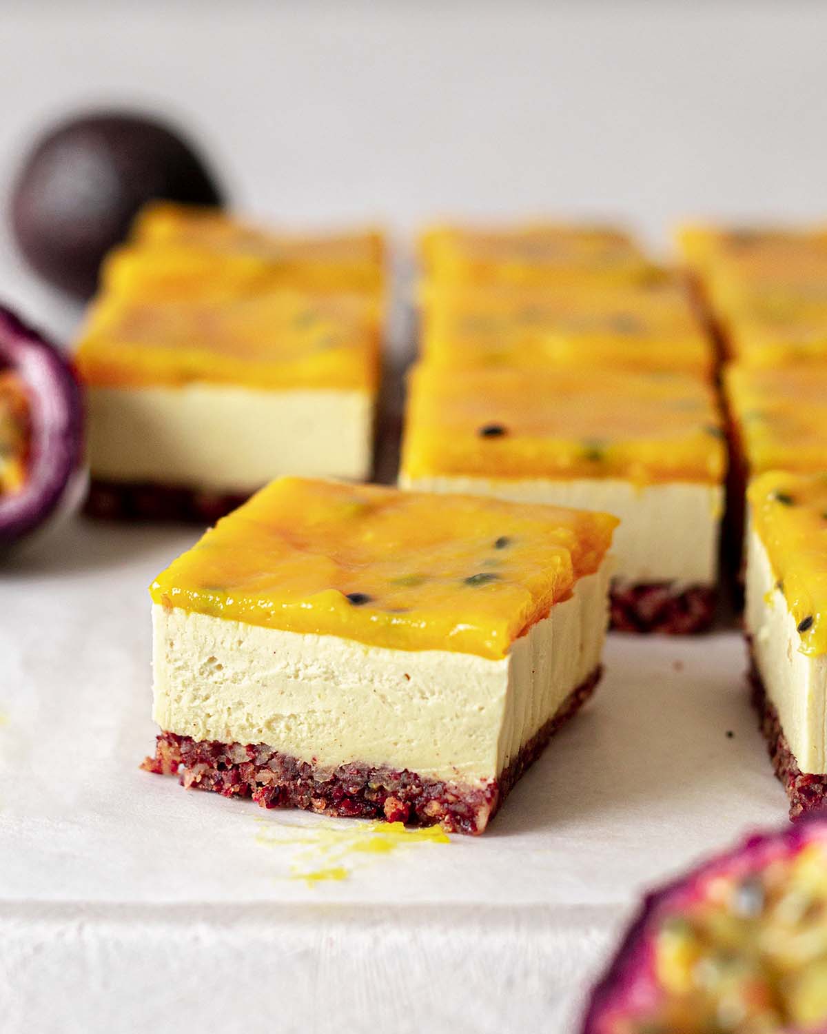 Close up of one cheesecake bar focusing on the smooth texture of the cheesecake filling.