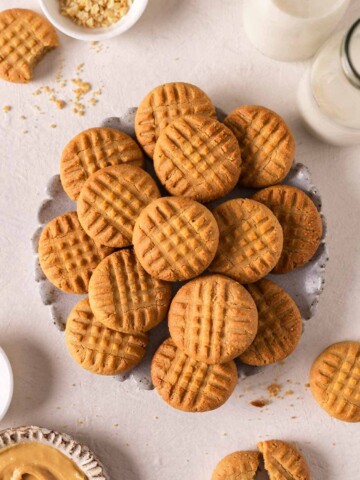 Lots of 3 ingredient peanut butter cookies on a decorative plate.