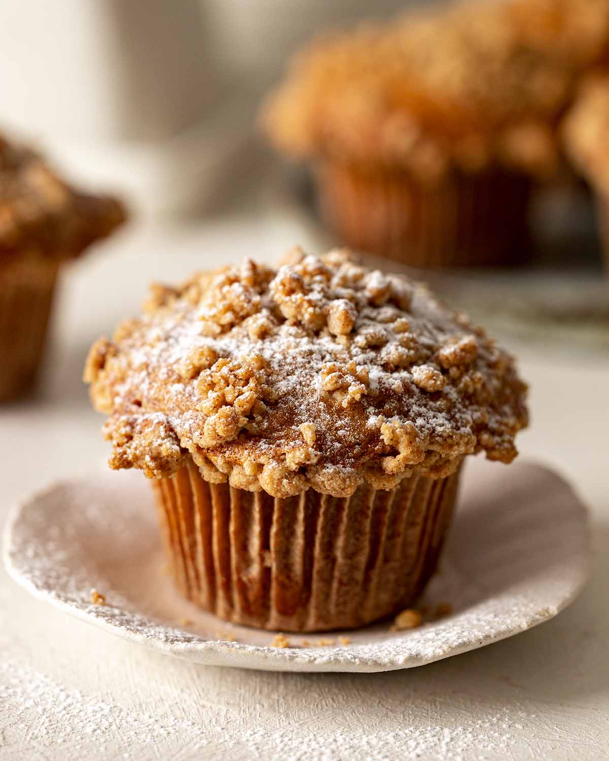 Close up of banana muffin with powdered sugar.