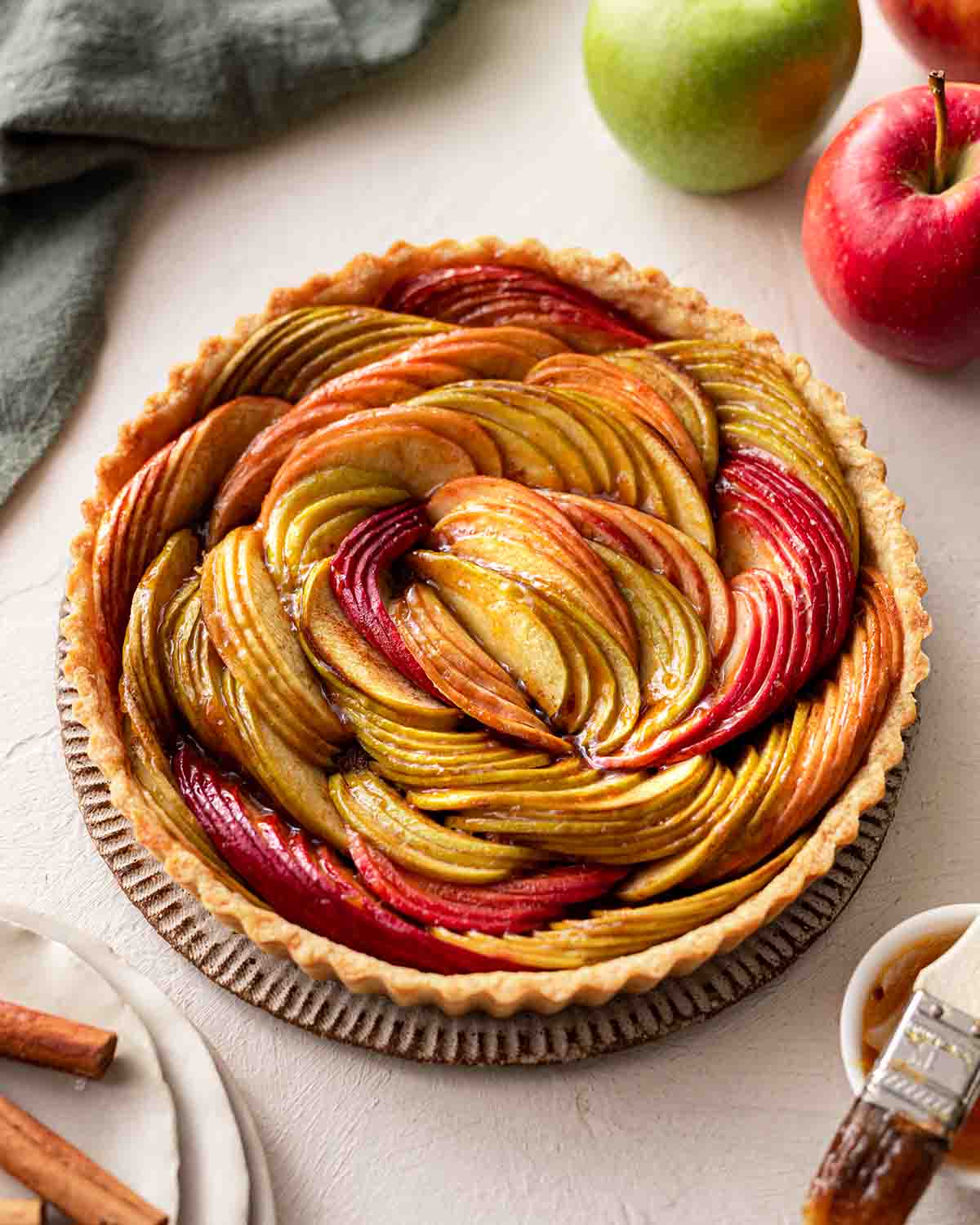 Baked tart with glossy golden brown sliced apples.