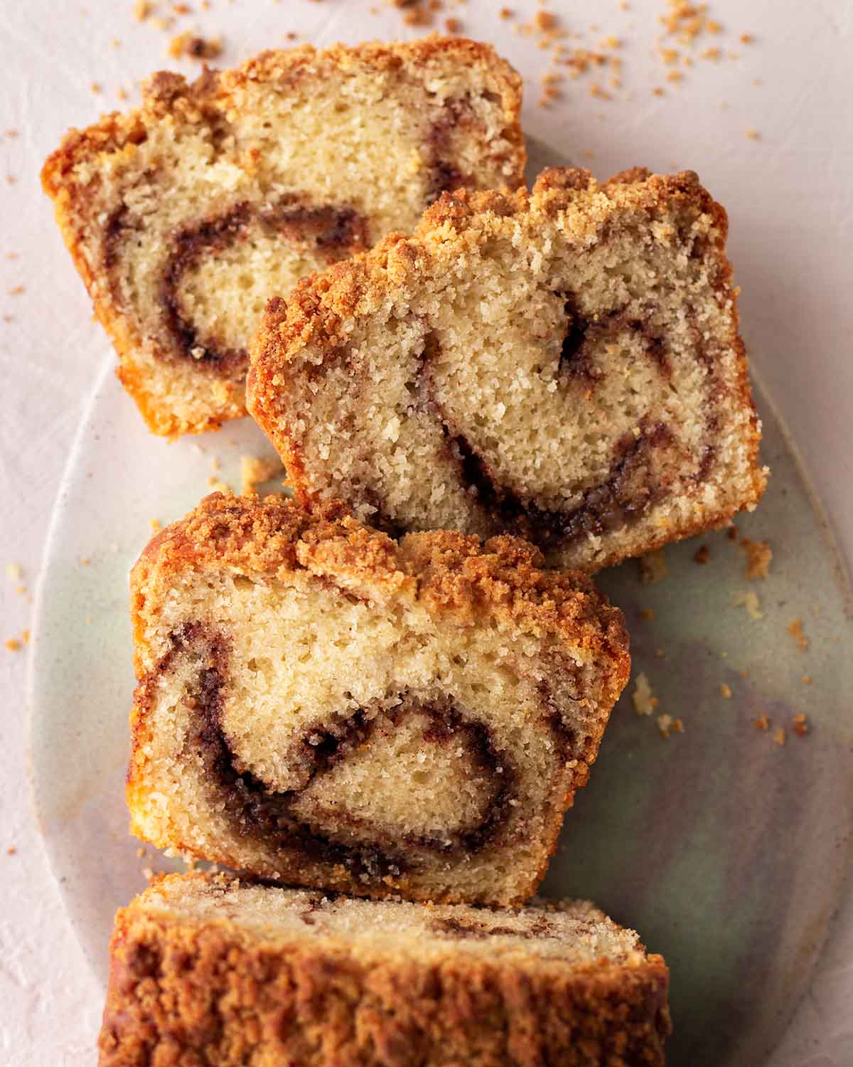 Overhead image of cinnamon bread with three slices cut out showing swirl patter.