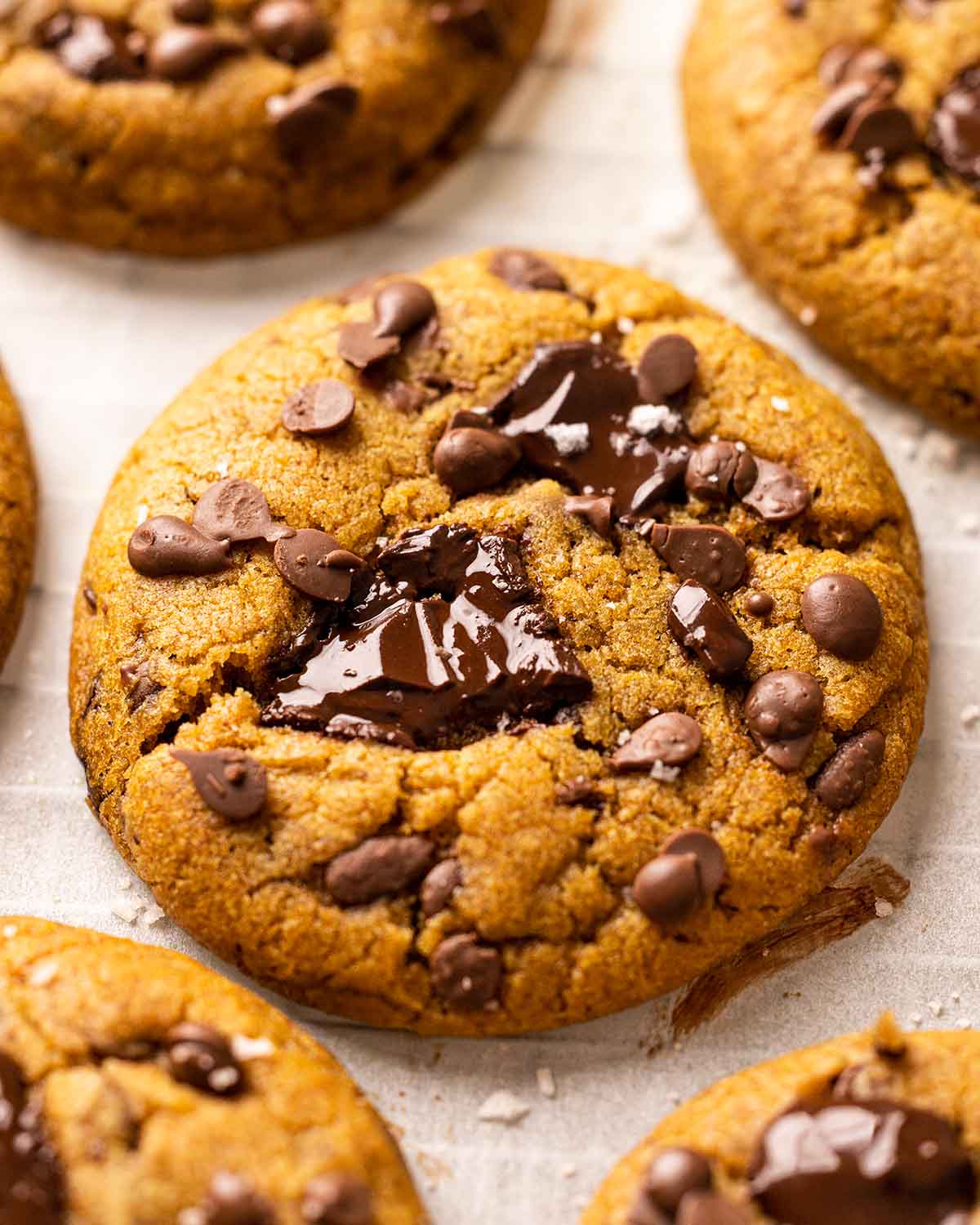 Close up of vegan pumpkin cookies on lined baking tray.