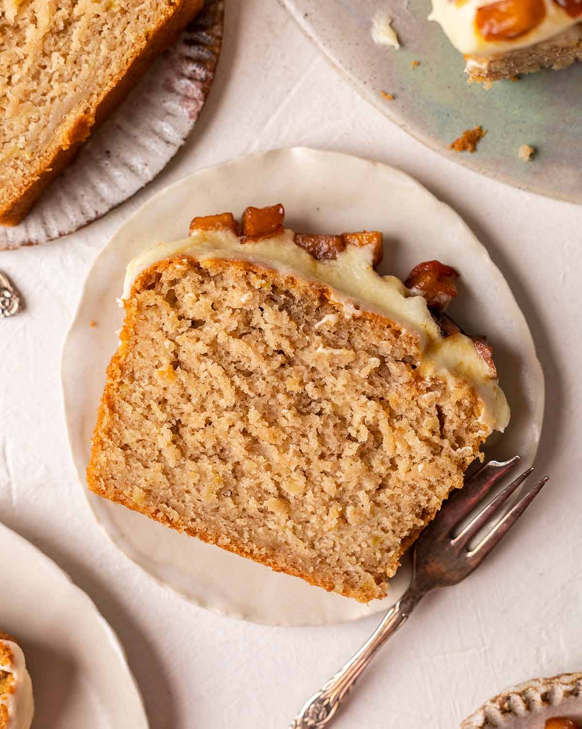 Close up of slice of apple bread showing fluffy moist texture.