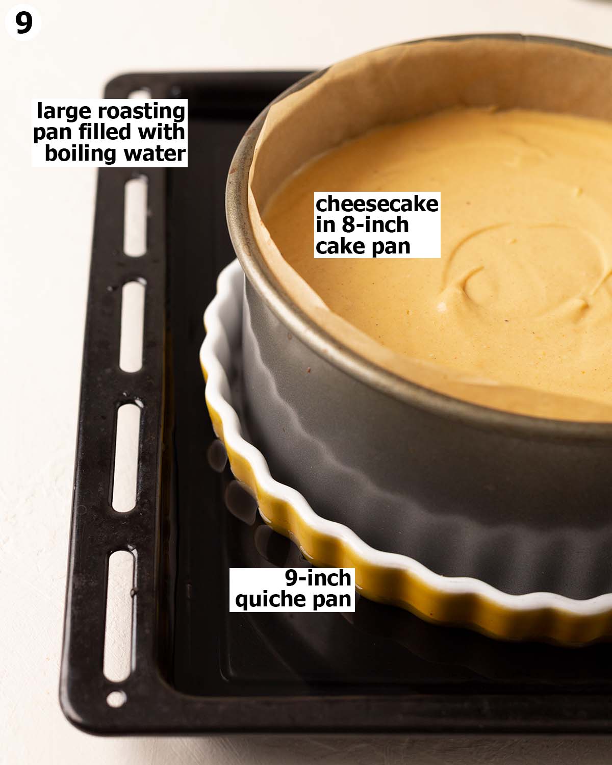 Unbaked cheesecake sitting in slightly larger quiche pan which is in a large roasting pan filled with boiling water.