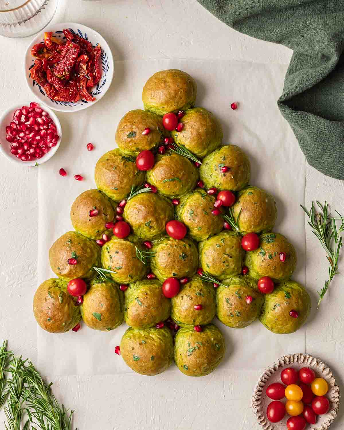 Green colored pull-apart bread shaped as a Christmas tree.