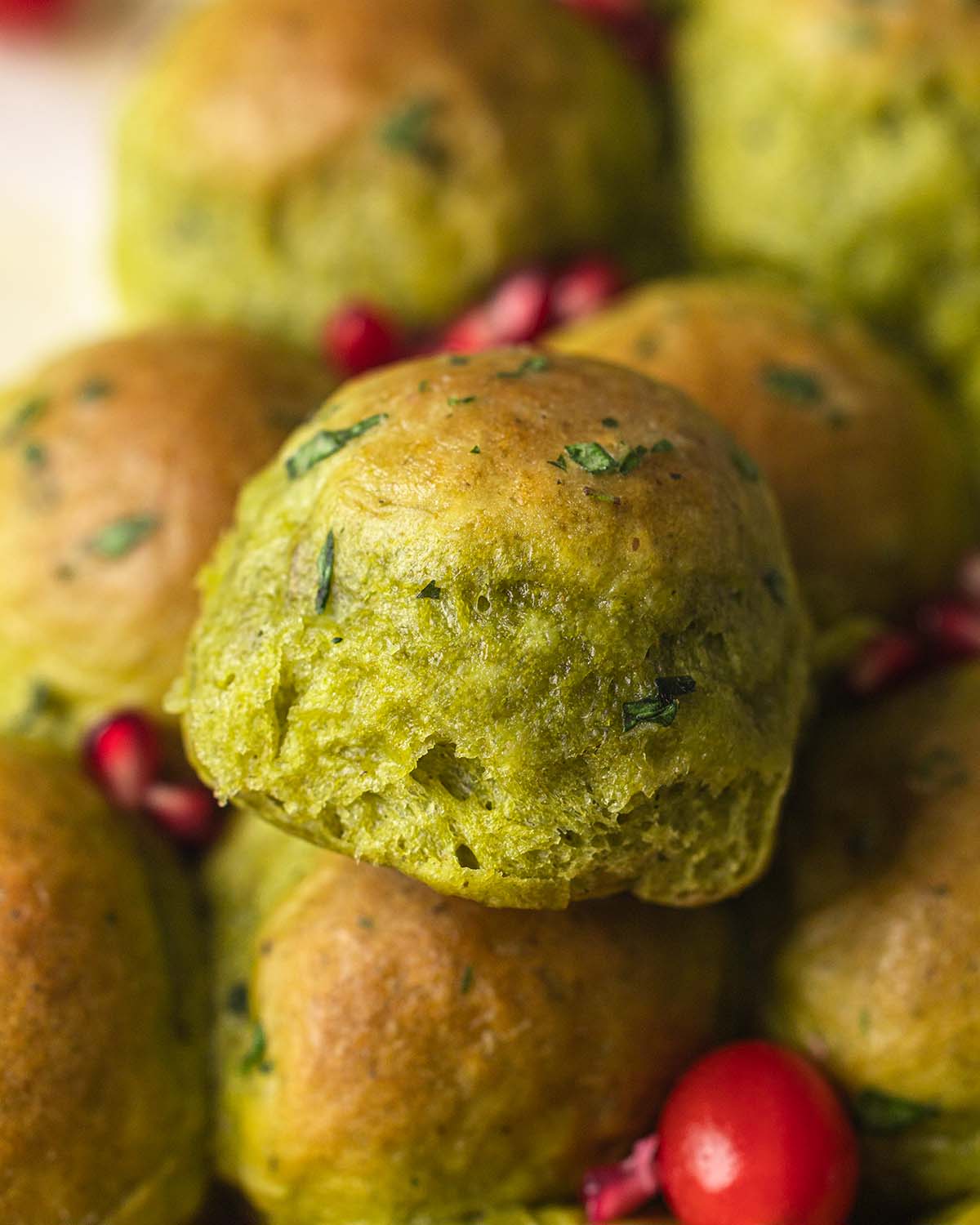 Close up of a fluffy green-colored bread bun.