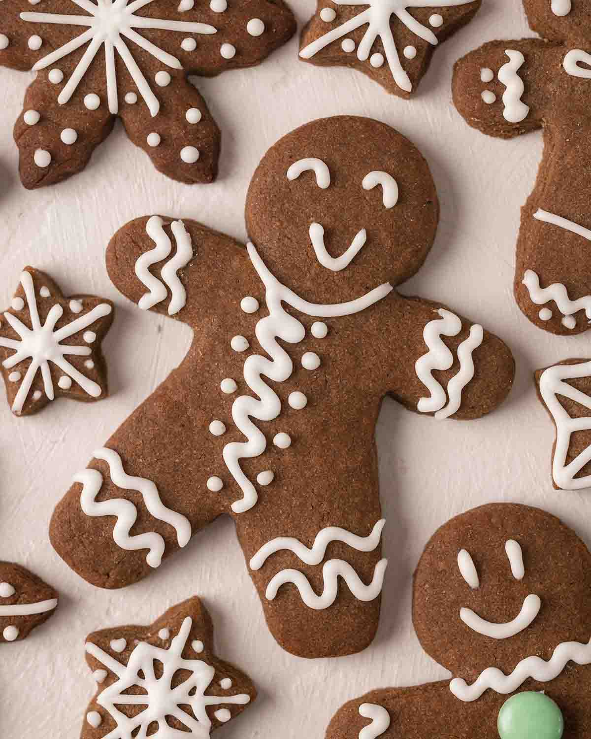 Close up of one gingerbread person, decorated with swirls and smiley face.