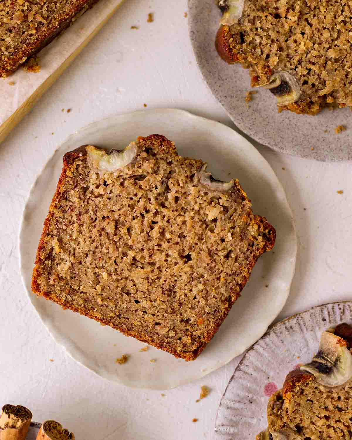 Close up of one slice of banana bread on plate showing fluffy texture.