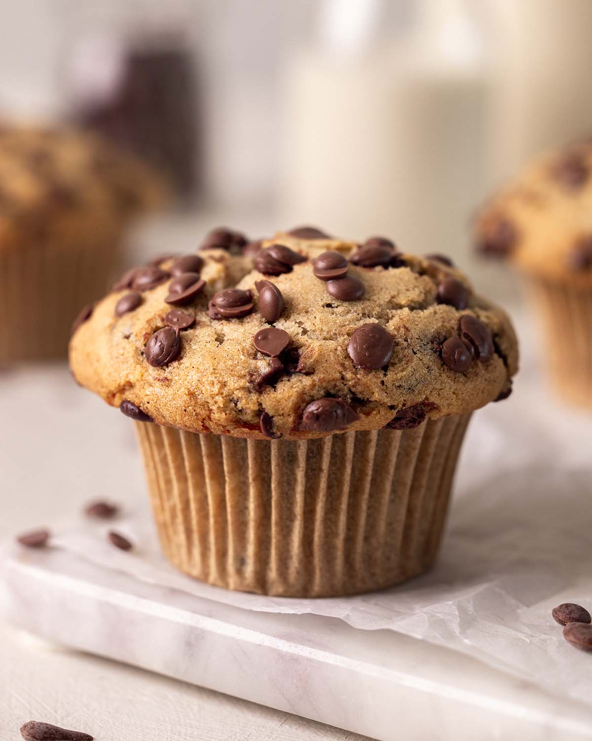 Side angle of chocolate chip muffin showing large muffin top.