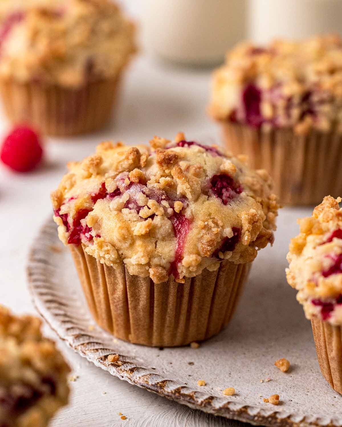 Close up of raspberry muffins on plate.